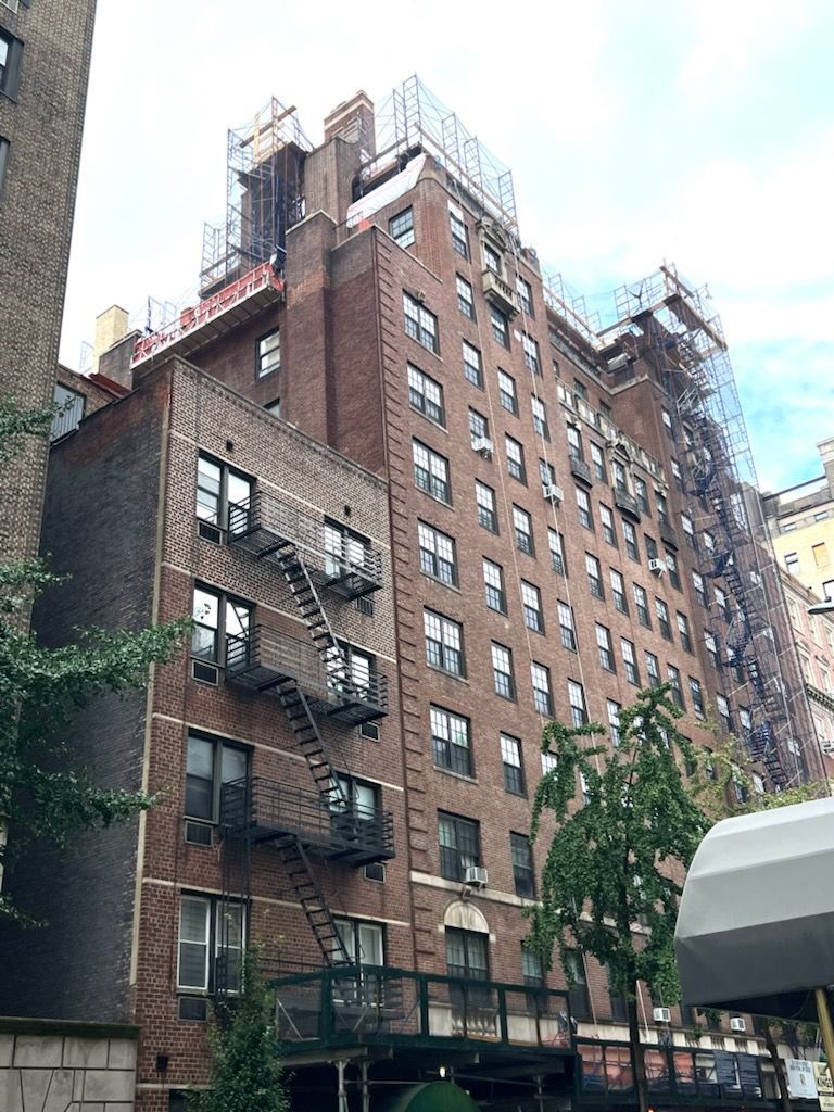 A large brick building with a fire escape on the side of it.