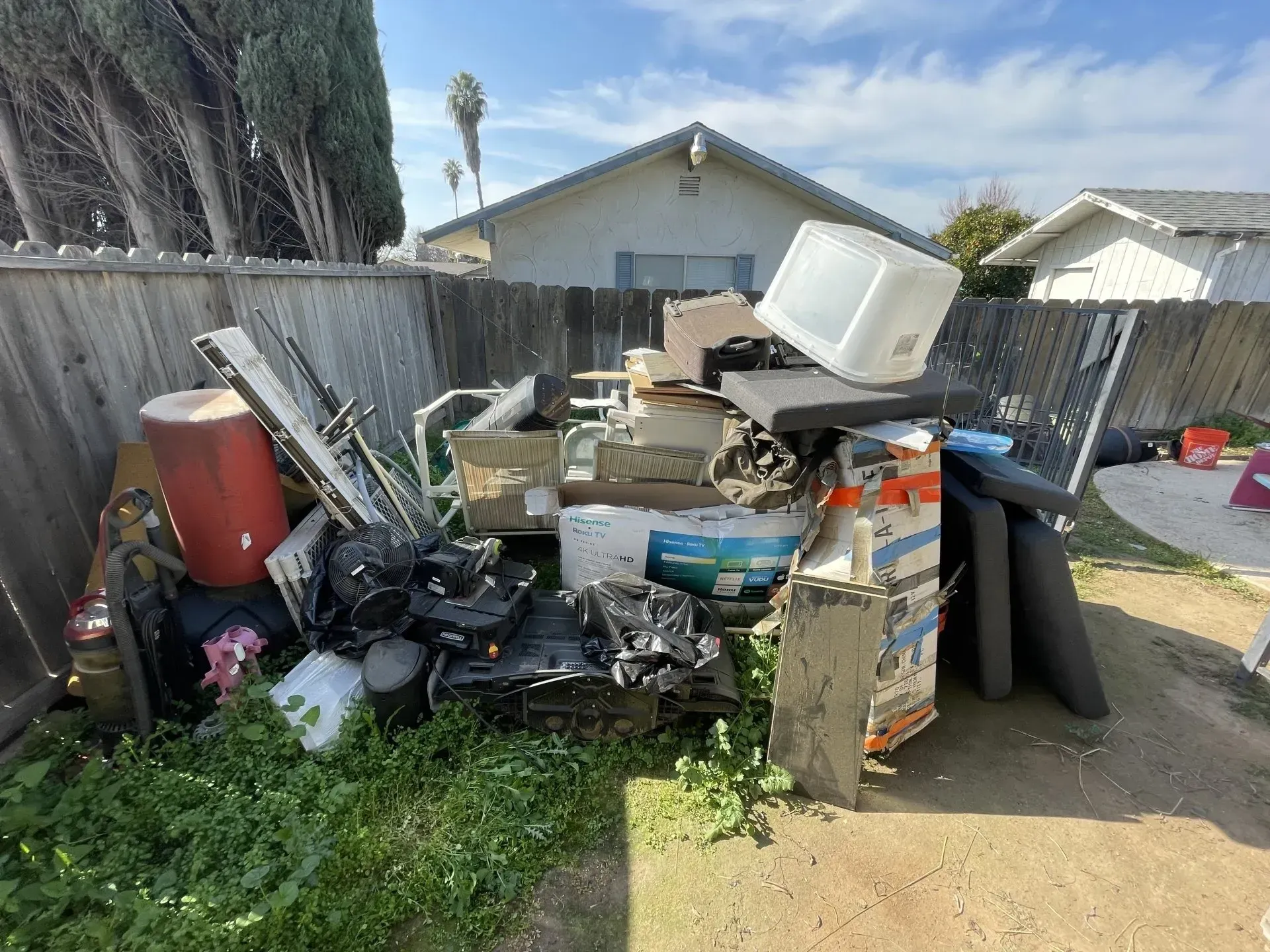a man is carrying a bag of trash next to a garbage truck .