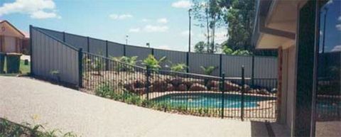 fence surrounding backyard pool