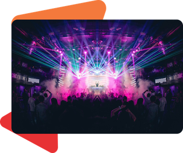 A crowd of people dances in a dark nightclub filled with bright, colorful laser lights and stage fog.