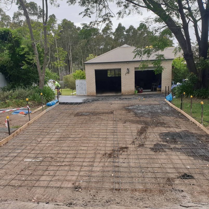 A Concrete Driveway Is Being Built in Front of A House — Turn It Crete in Ulladulla, NSW