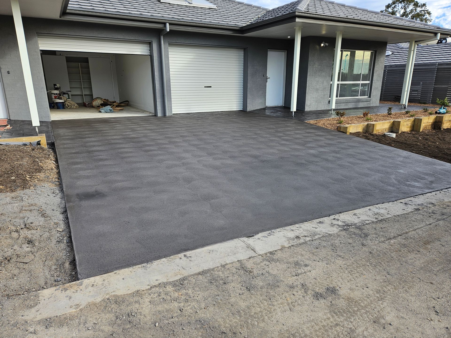 A Concrete Driveway Is Being Built in Front of A House — Turn It Crete in St Georges Basin, NSW