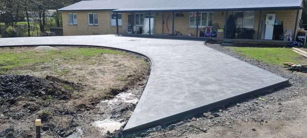 A Concrete Driveway Is Being Built In Front Of A House — Turn It Crete in St Georges Basin, NSW