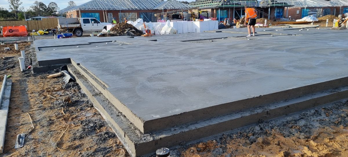 A Large Concrete Slab Is Sitting On Top Of A Dirt Field — Turn It Crete in St Georges Basin, NSW