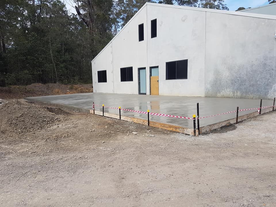 A Large White Building With A Concrete Floor In Front Of It — Turn It Crete in St Georges Basin, NSW