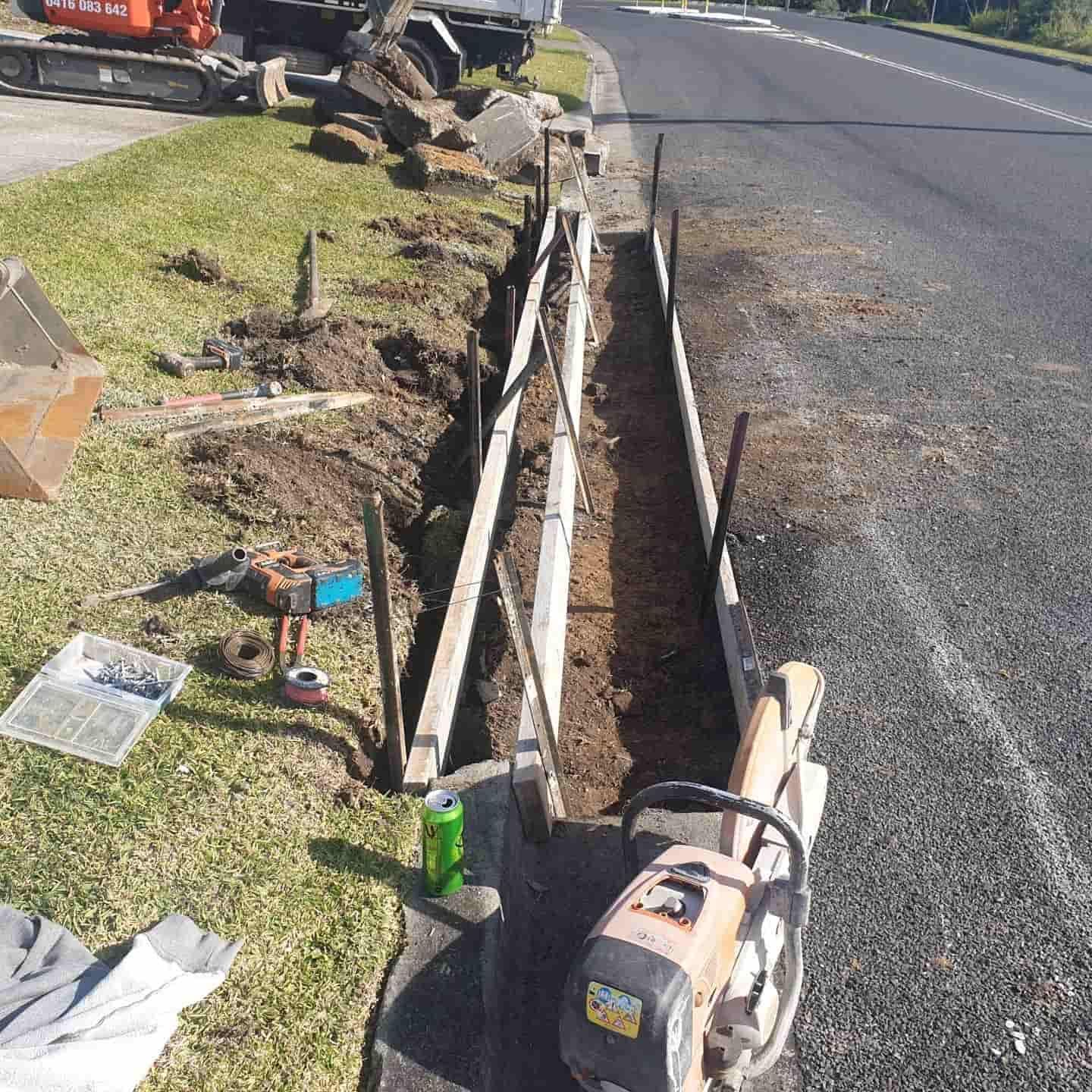 A Digger With Broken Concrete On The Side Of A Road — Turn It Crete in St Georges Basin, NSW