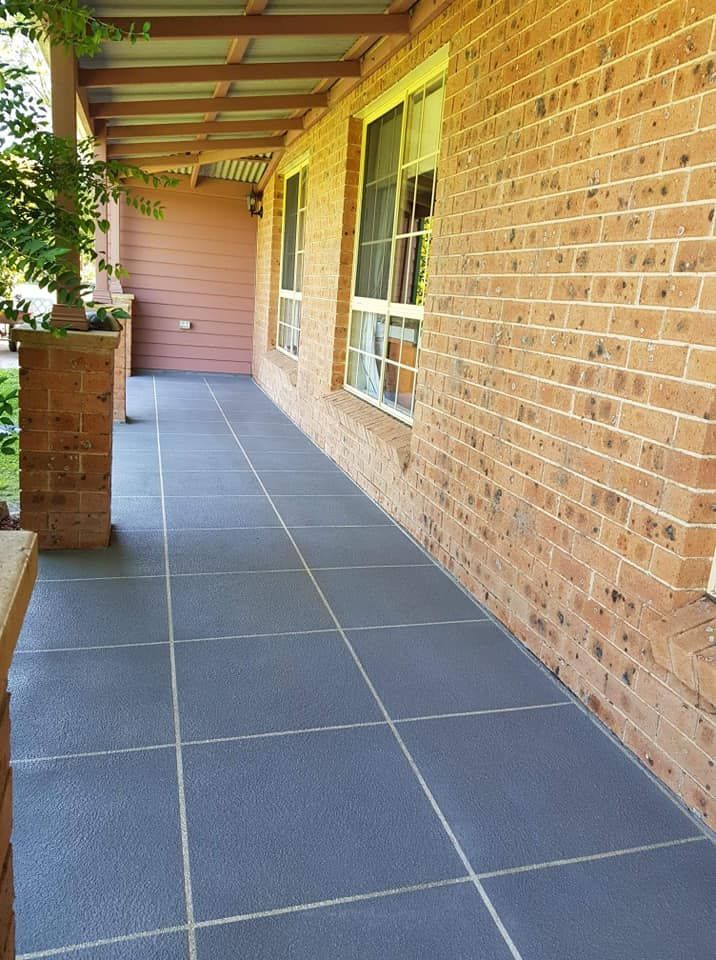 A Brick Building With A Tiled Walkway Leading To It — Turn It Crete in Gerringong, NSW