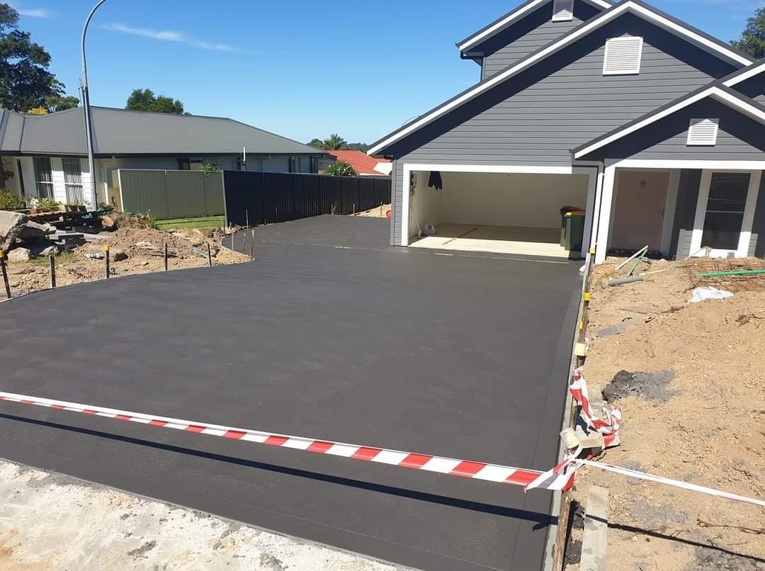 A concrete driveway is being built in front of a house — Turn It Crete in St Georges Basin, NSW