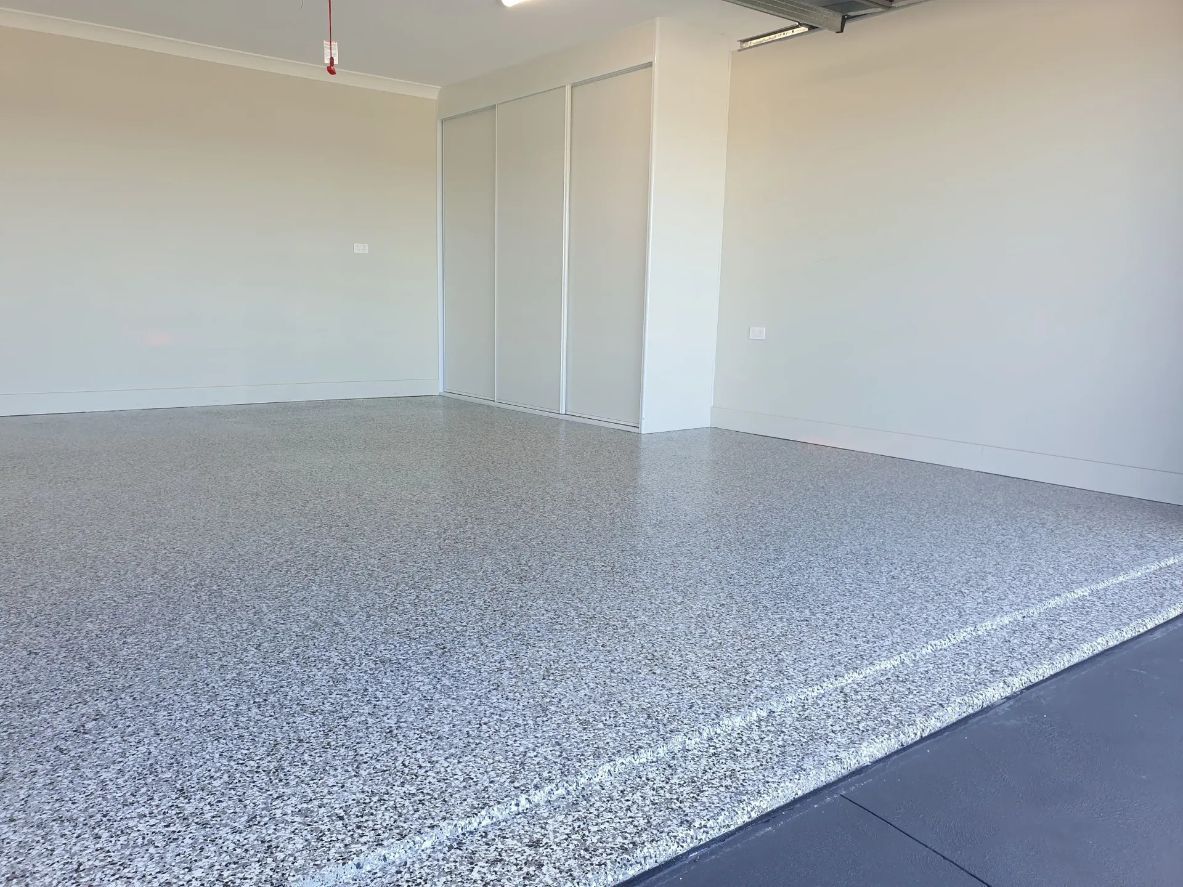 An Empty Garage with A Gray Floor and White Walls — Turn It Crete in Kiama, NSW