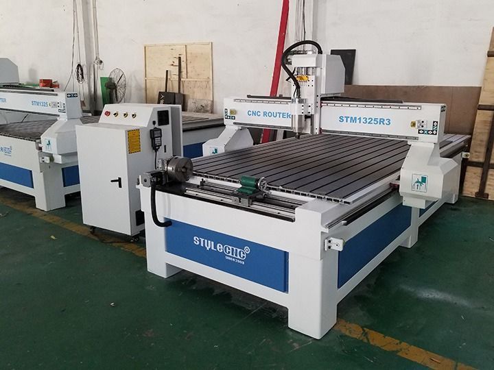 A CNC router machine in a workshop, white and blue colors.