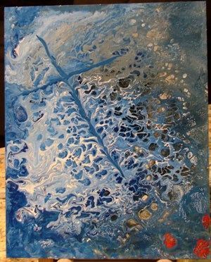 A blue and white painting on a wooden table