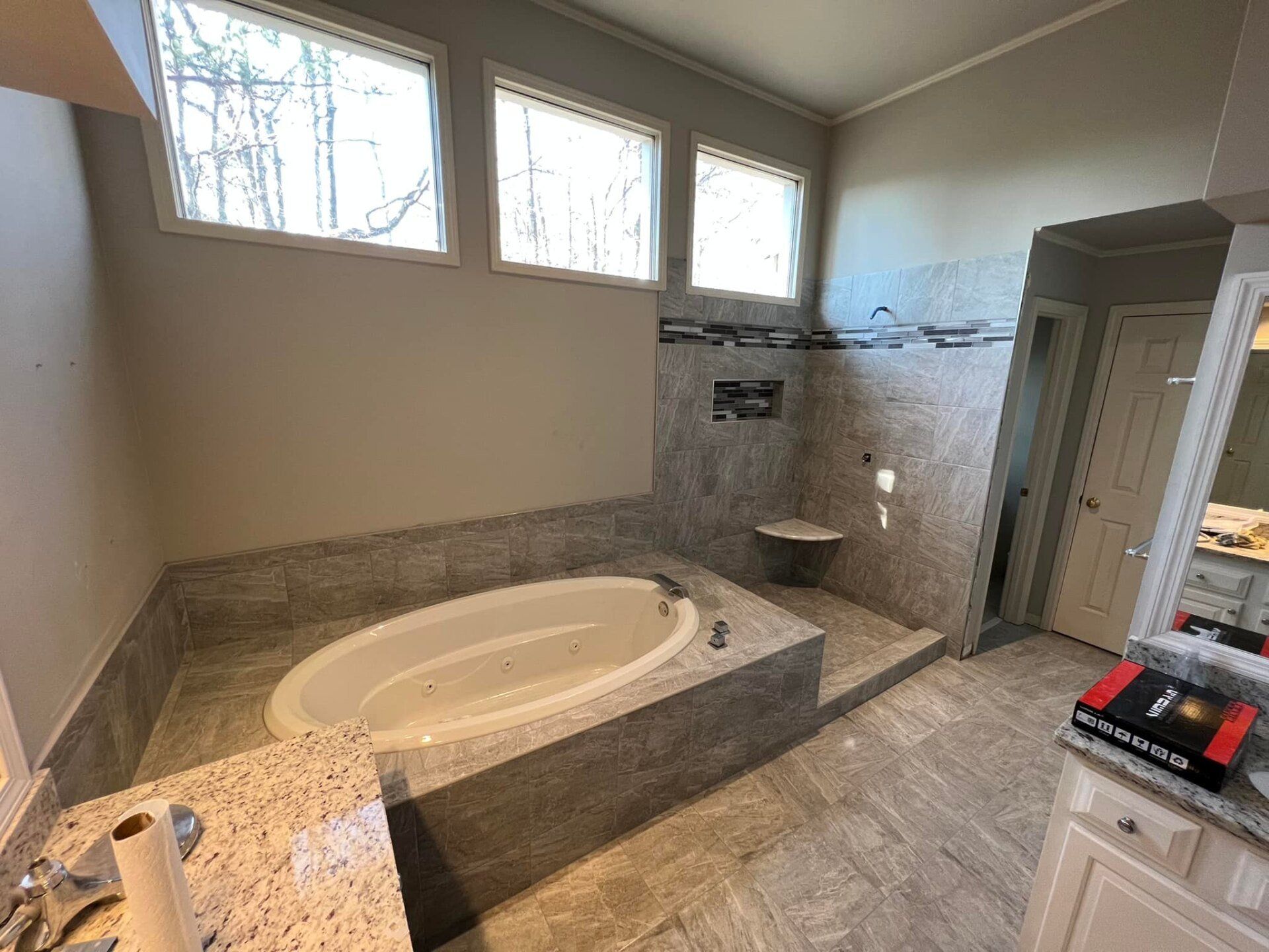 A bathroom with a bathtub , sink , and mirror.