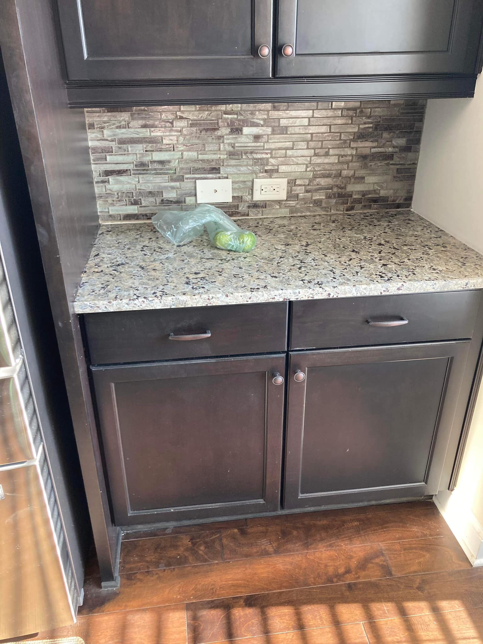 There is a bag of apples on the counter in the kitchen.