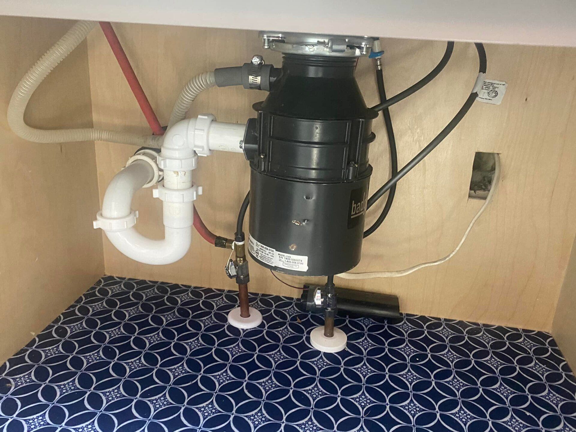 A sink with a garbage disposal underneath it