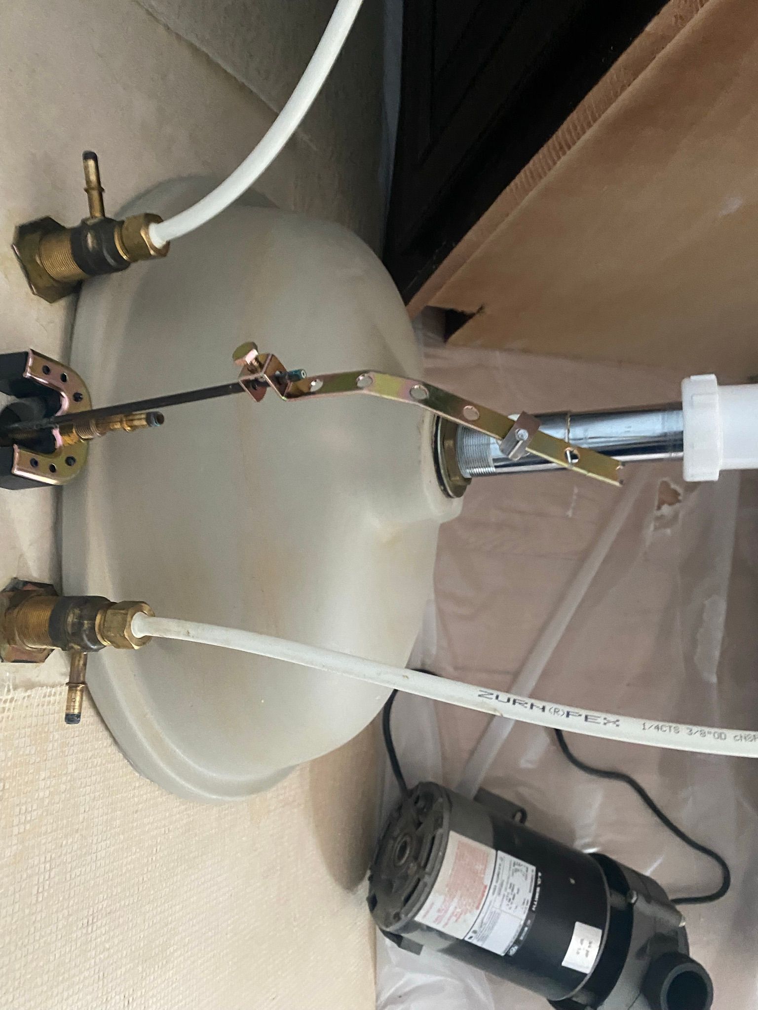 A sink with a motor attached to it and a hose coming out of it.