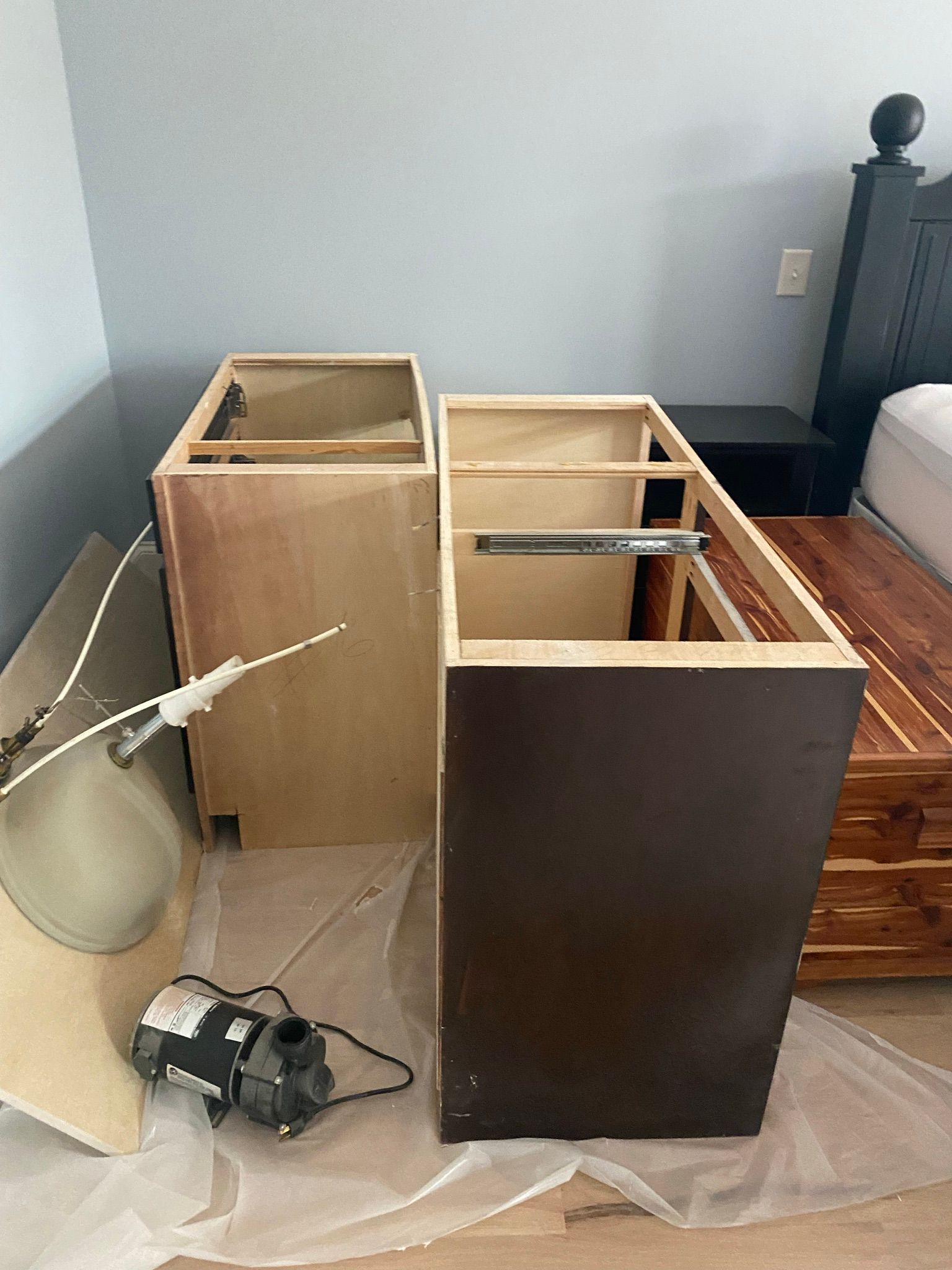A bunch of wooden cabinets are sitting on the floor in a room.