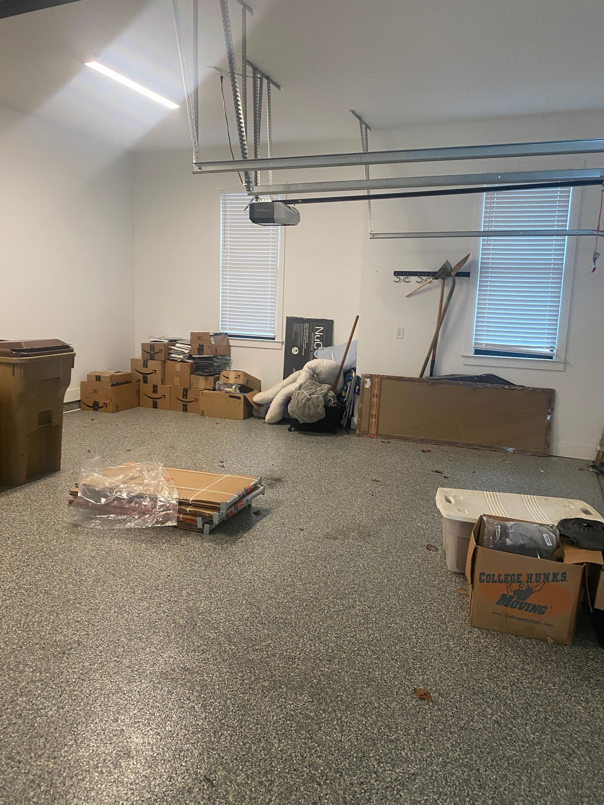 A garage with a lot of boxes and boxes on the floor.