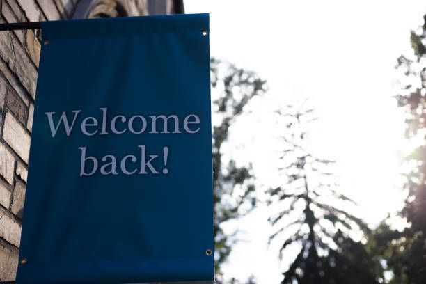 A blue sign that says welcome back on it