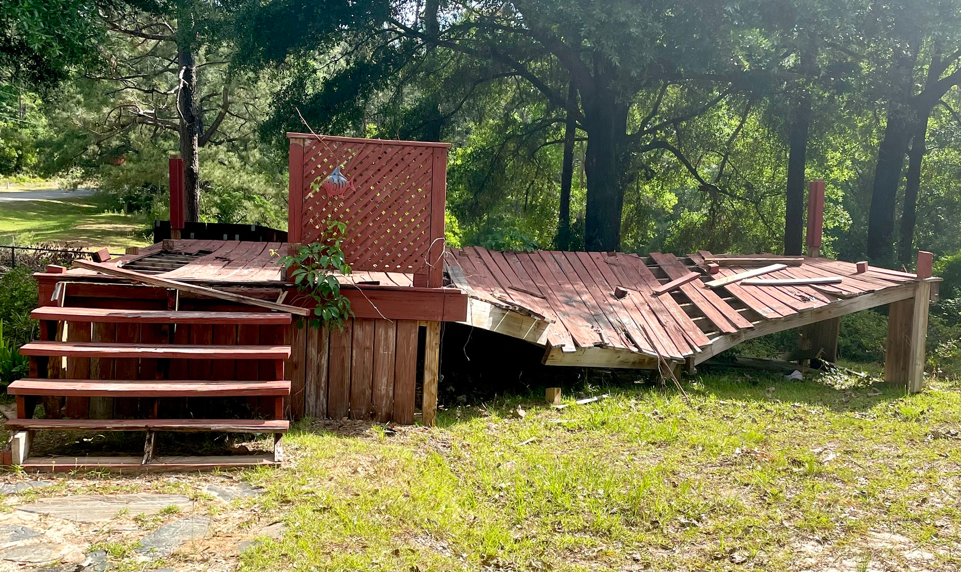 A pile of wood is sitting on the back of a truck.