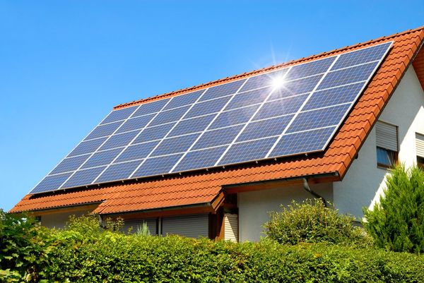 Solar panels on a house harnessing solar energy from the sun.