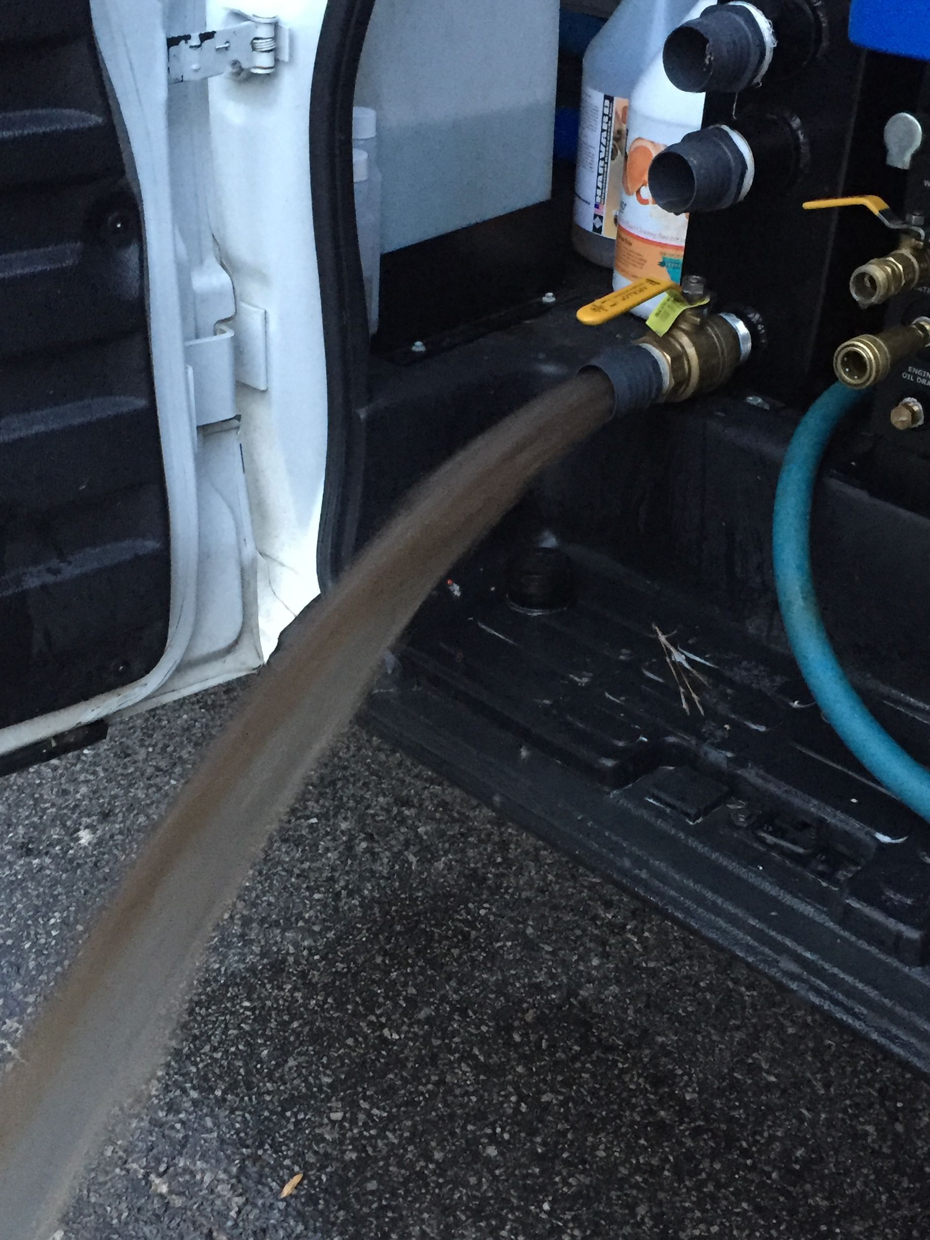A hose is coming out of the back of a van