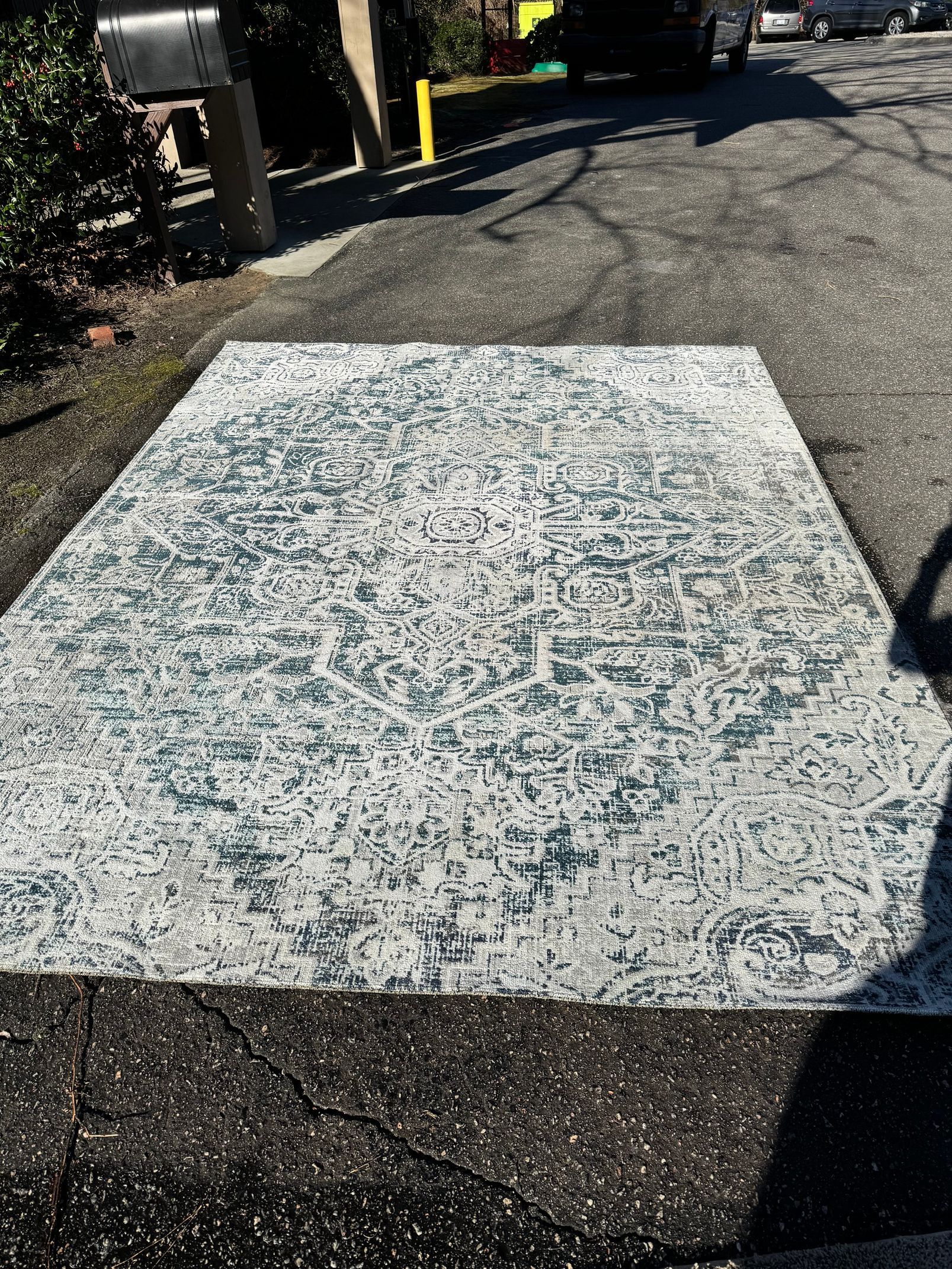 A large piece of concrete is sitting on the side of a road.