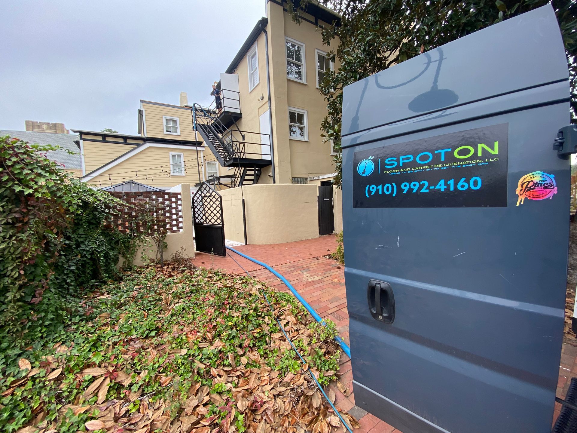 A proton van is parked in front of a building