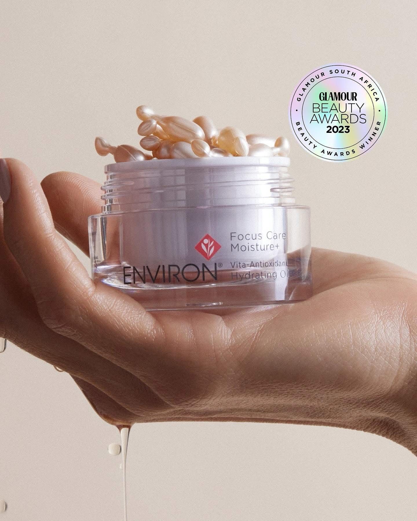 Hand holding Environ Peptide  Moisturizer jar with capsules. Holographic 