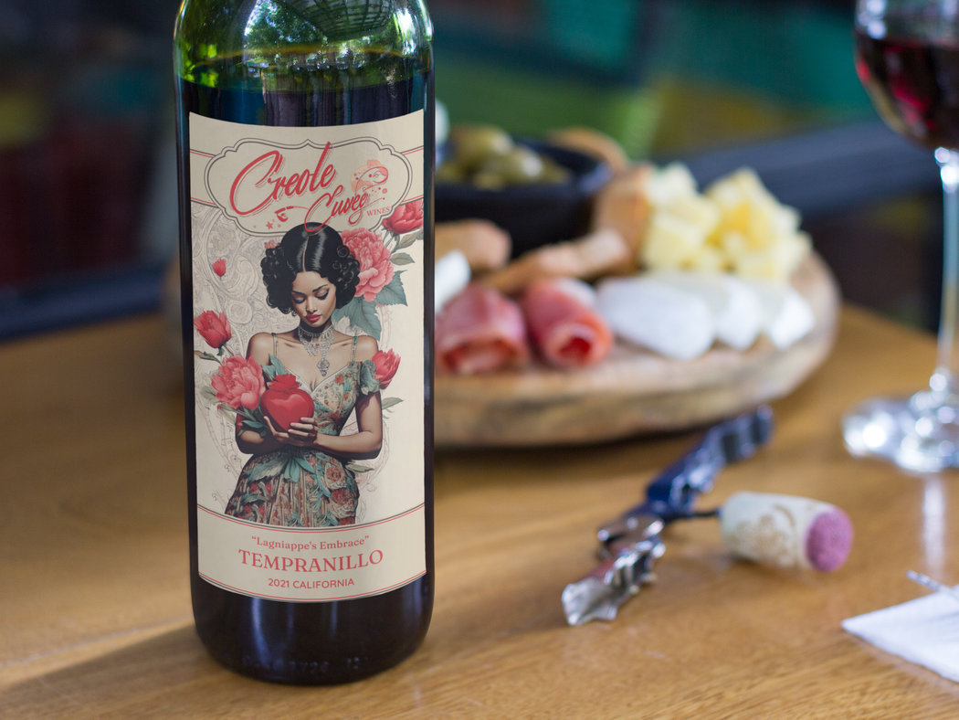 Wine bottle label with woman holding hearts, next to cheese and wine.