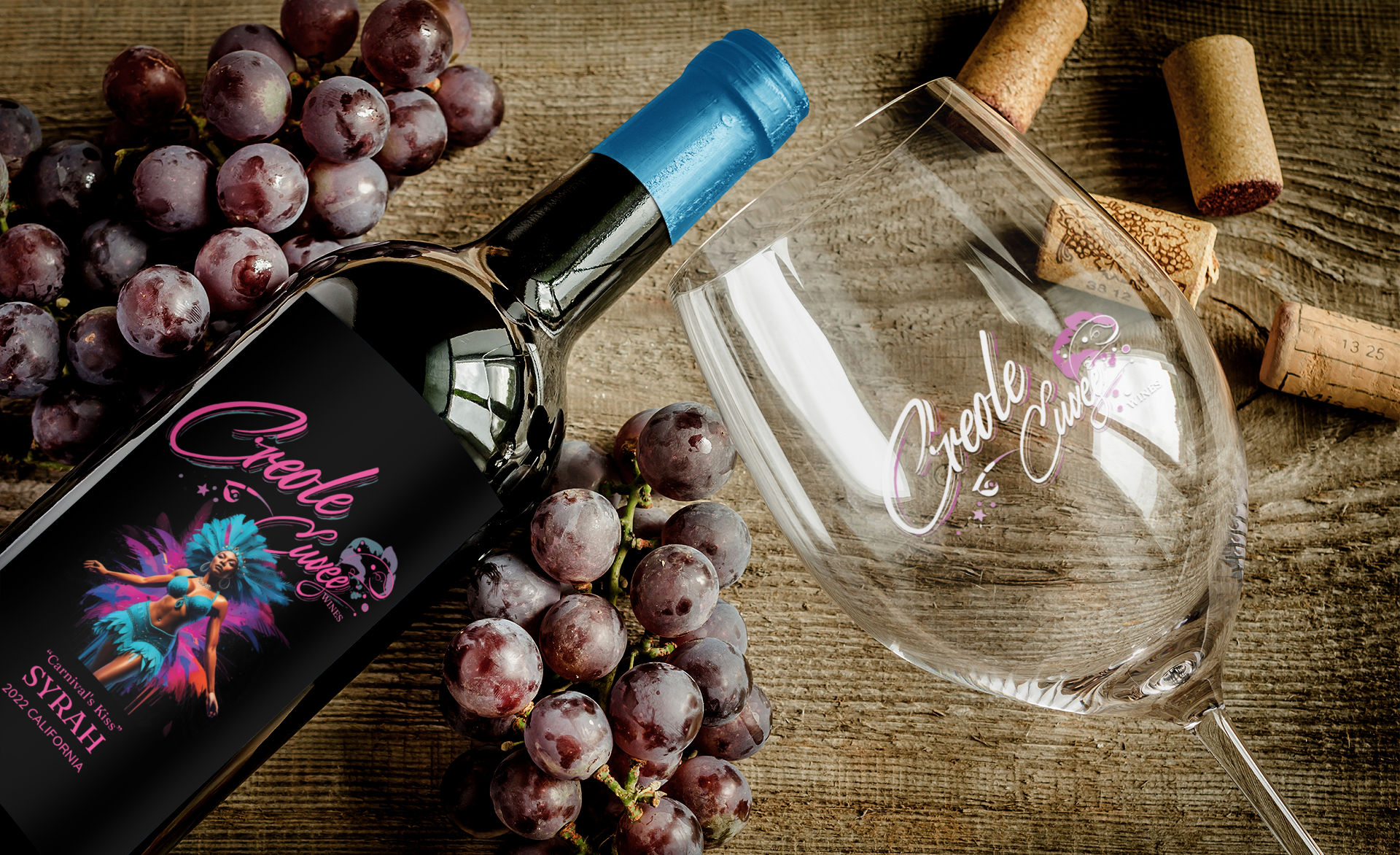 Wine bottle and glass with grapes on a wooden surface. Bottle label has a colorful dancer illustration.