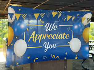 A blue and yellow banner that says `` we appreciate you ''