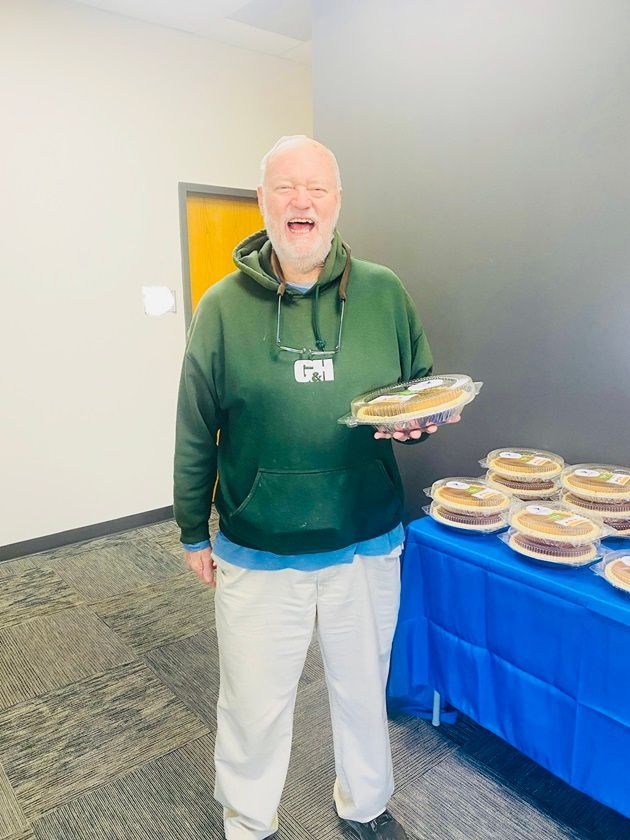 Client picking up their pie at the pumpkin pie give-away