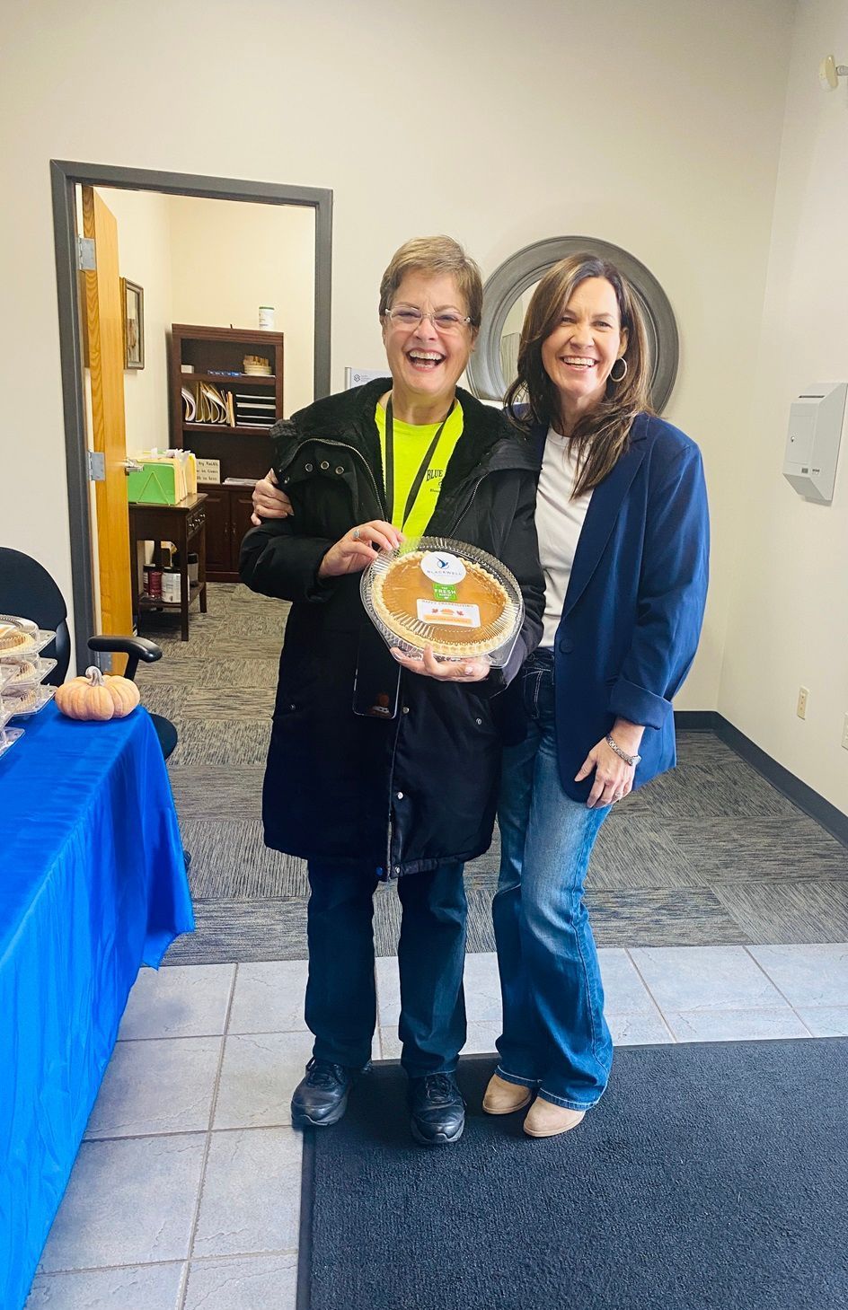 Client picking up their pie at the pumpkin pie give-away