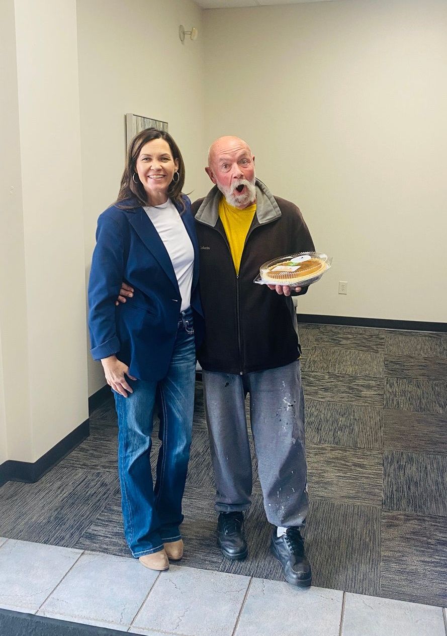 Client picking up their pie at the pumpkin pie give-away