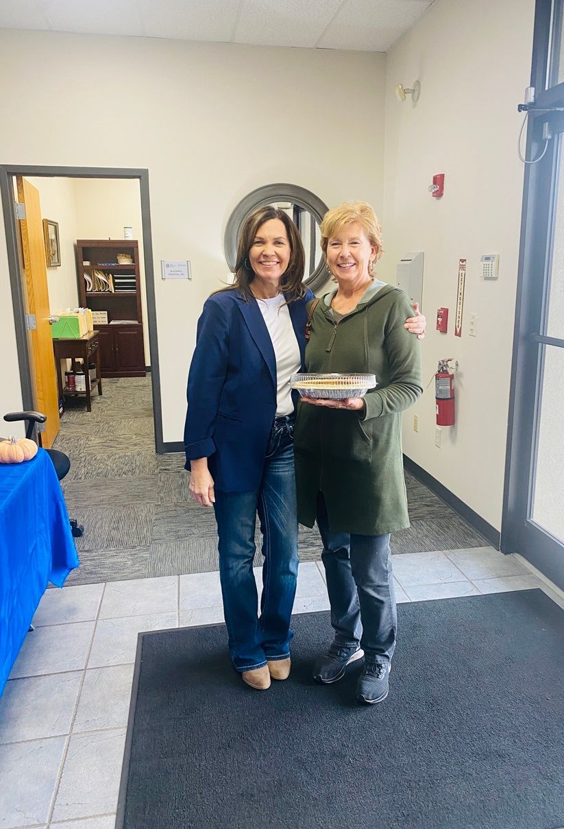 Client picking up their pie at the pumpkin pie give-away