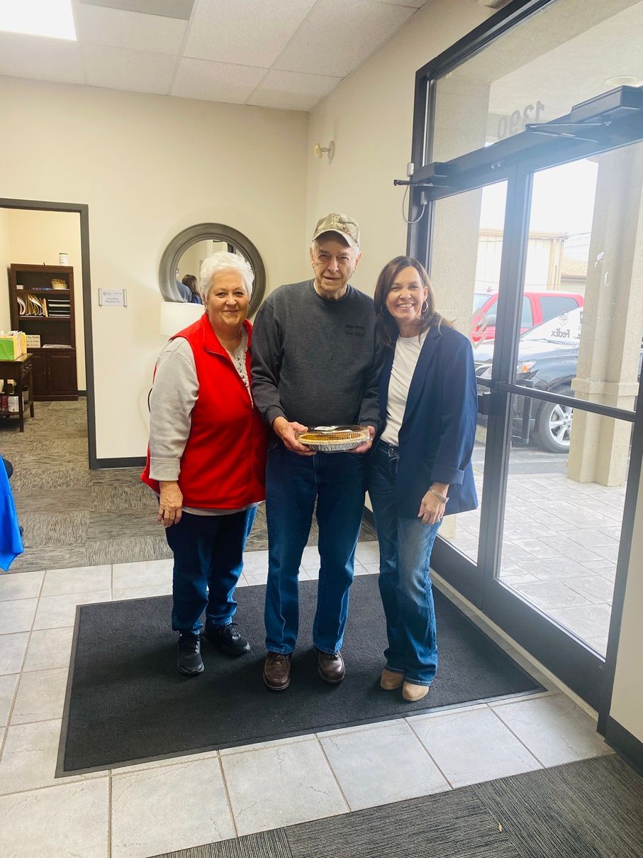 Client picking up their pie at the pumpkin pie give-away