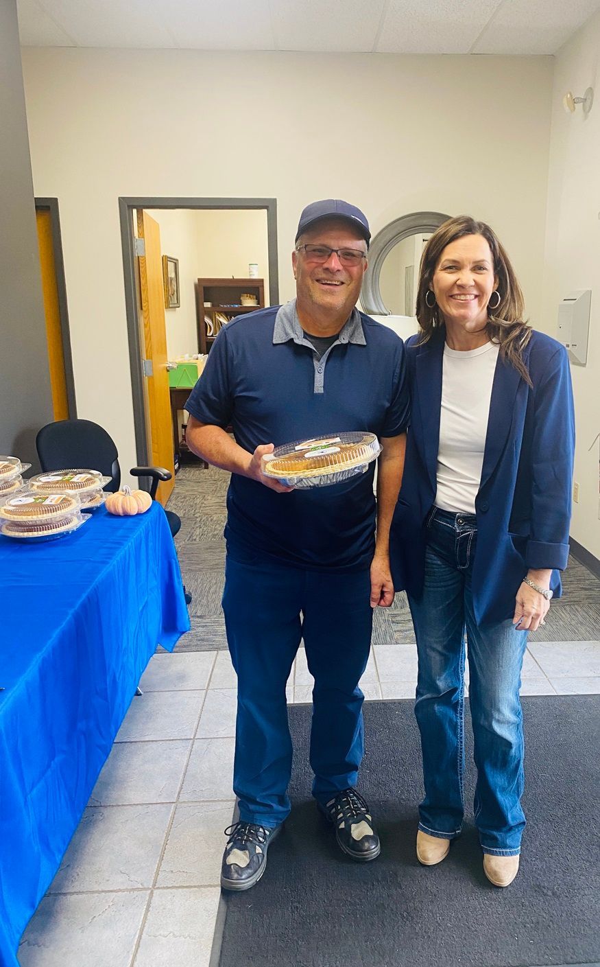 Client picking up their pie at the pumpkin pie give-away