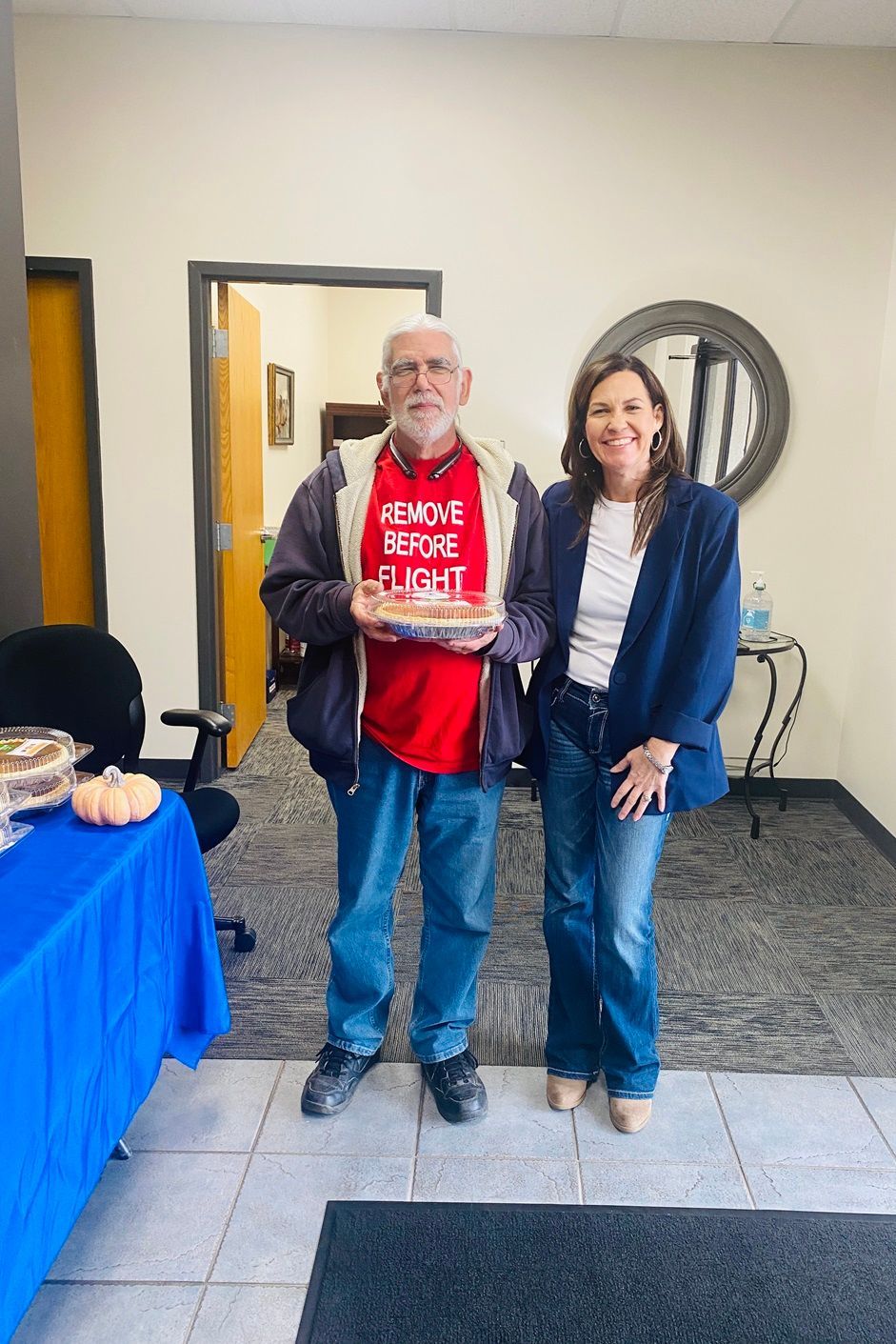 Client picking up their pie at the pumpkin pie give-away
