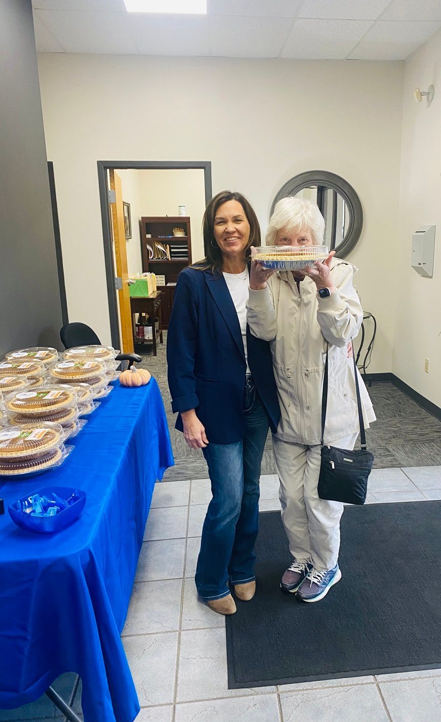 Client picking up their pie at the pumpkin pie give-away