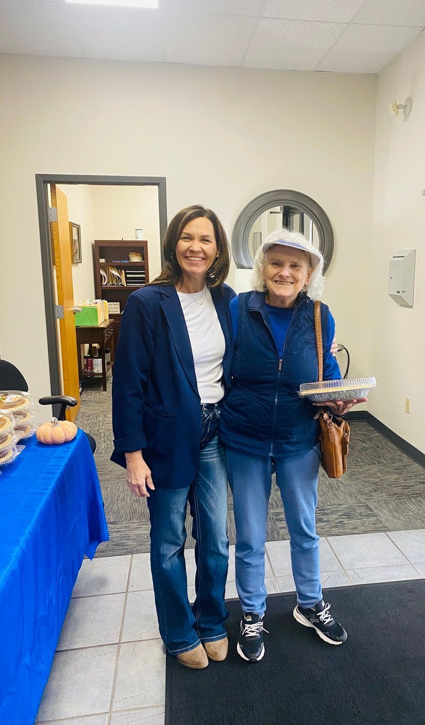Client picking up their pie at the pumpkin pie give-away