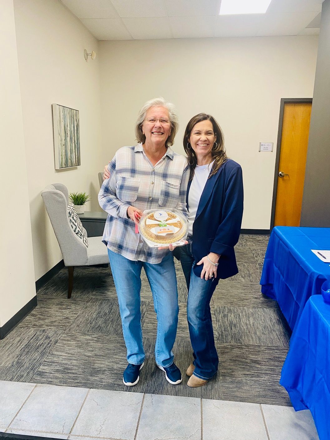 Client picking up their pie at the pumpkin pie give-away