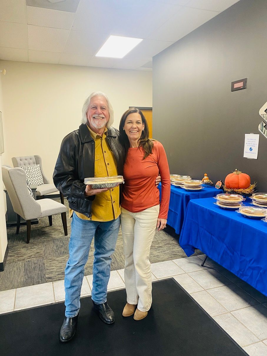 Client picking up their pie at the pumpkin pie give-away