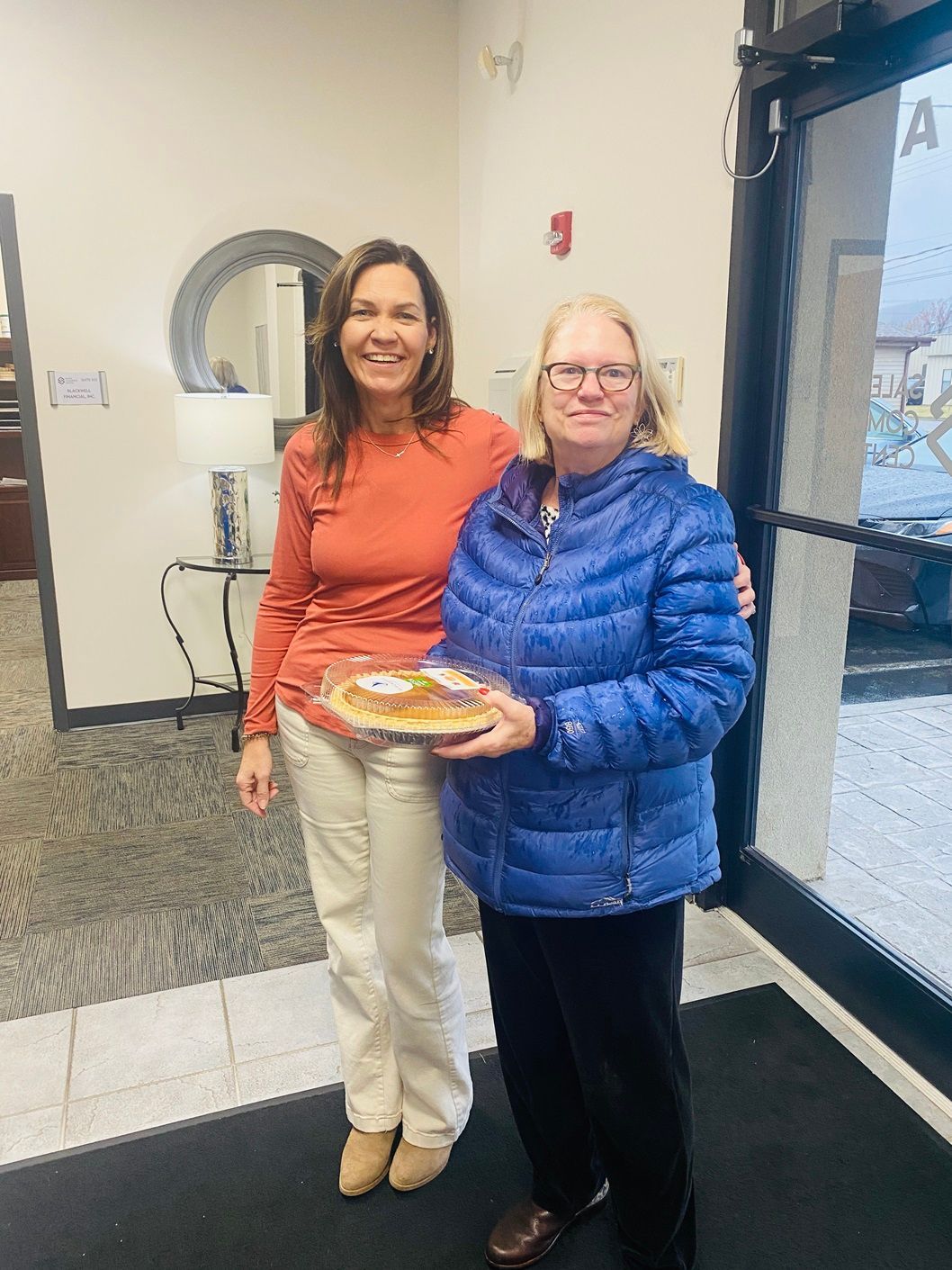 Client picking up their pie at the pumpkin pie give-away