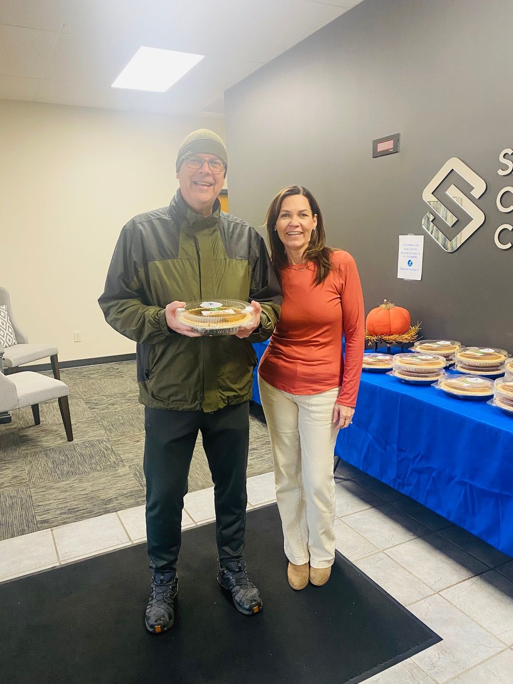 Client picking up their pie at the pumpkin pie give-away