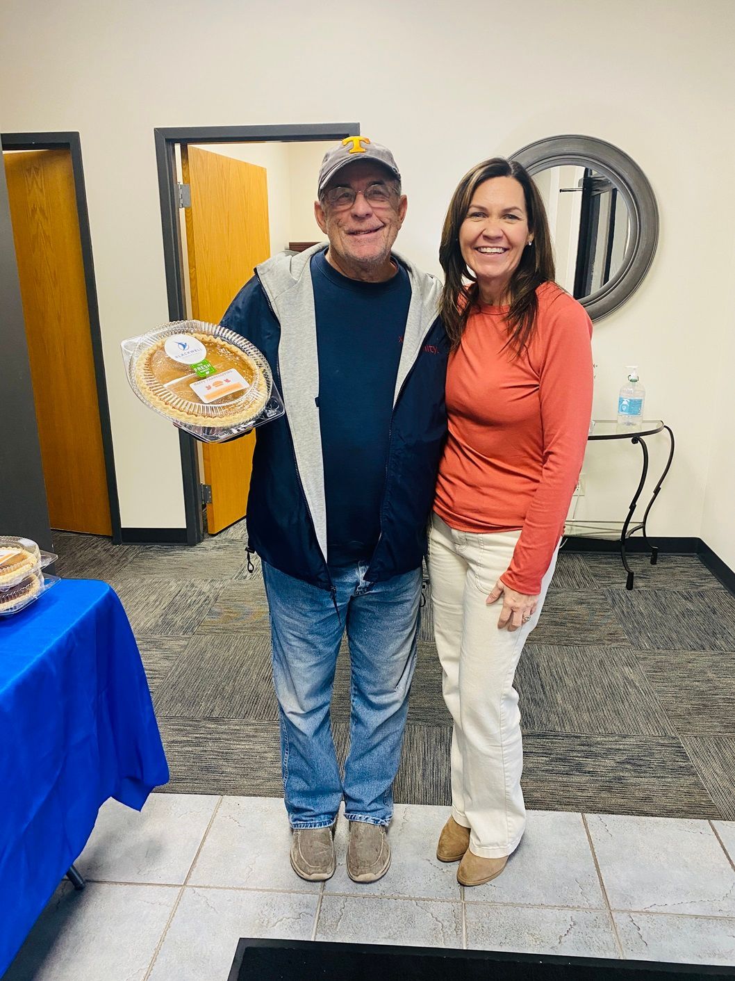 Client picking up their pie at the pumpkin pie give-away