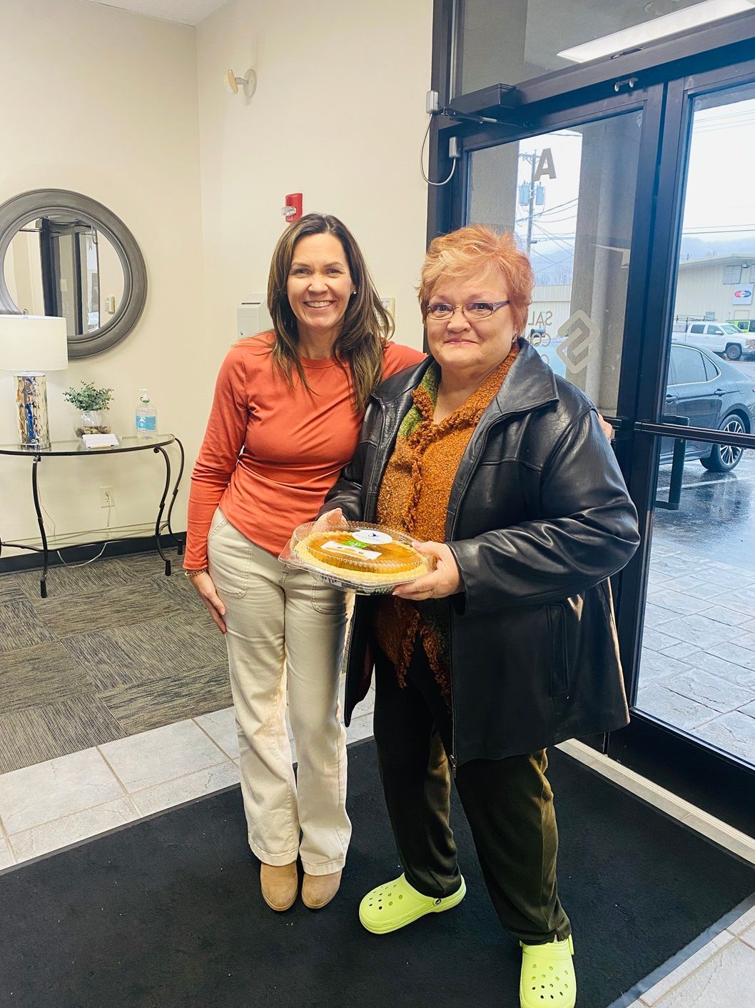 Client picking up their pie at the pumpkin pie give-away