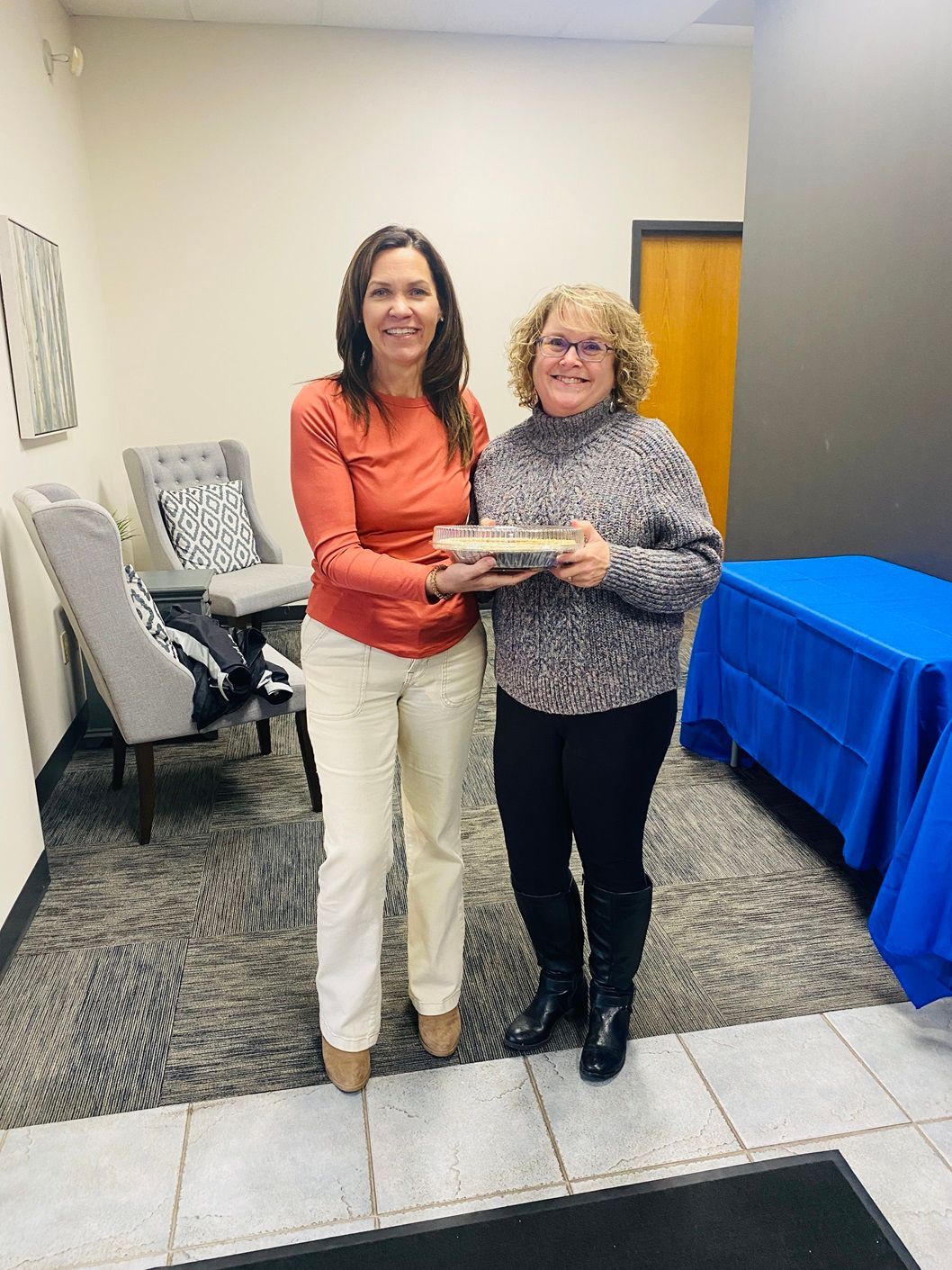 Client picking up their pie at the pumpkin pie give-away