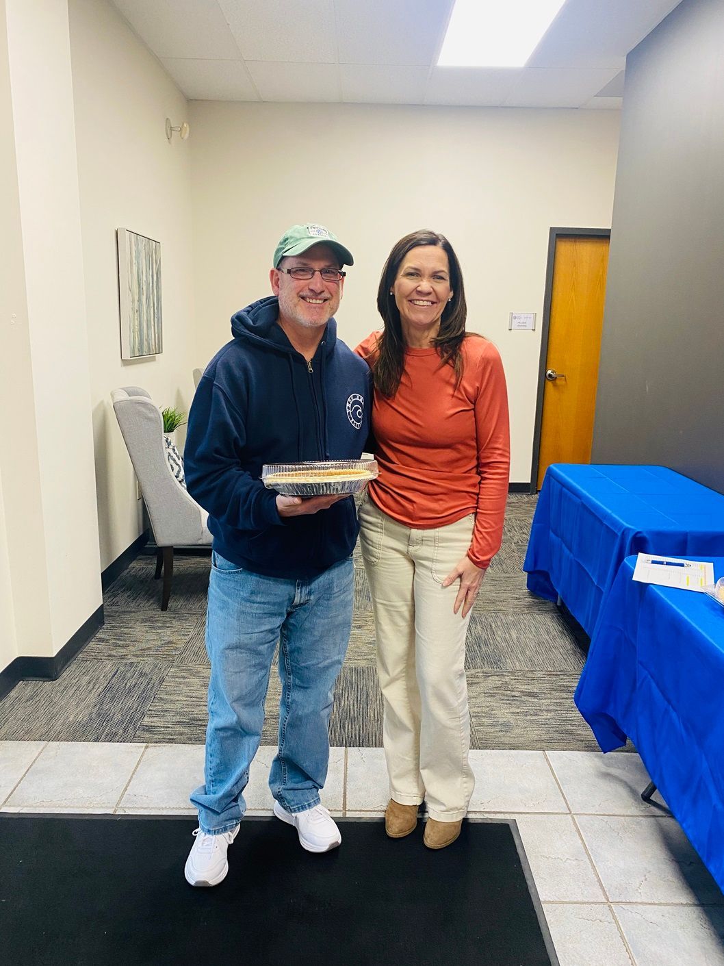 Client picking up their pie at the pumpkin pie give-away