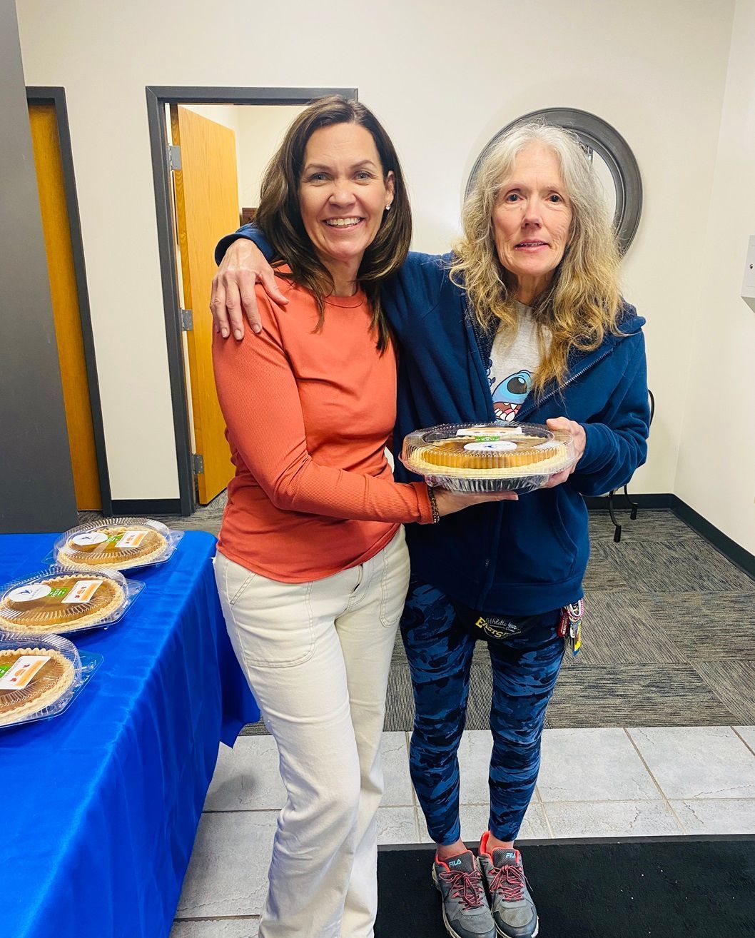 Client picking up their pie at the pumpkin pie give-away