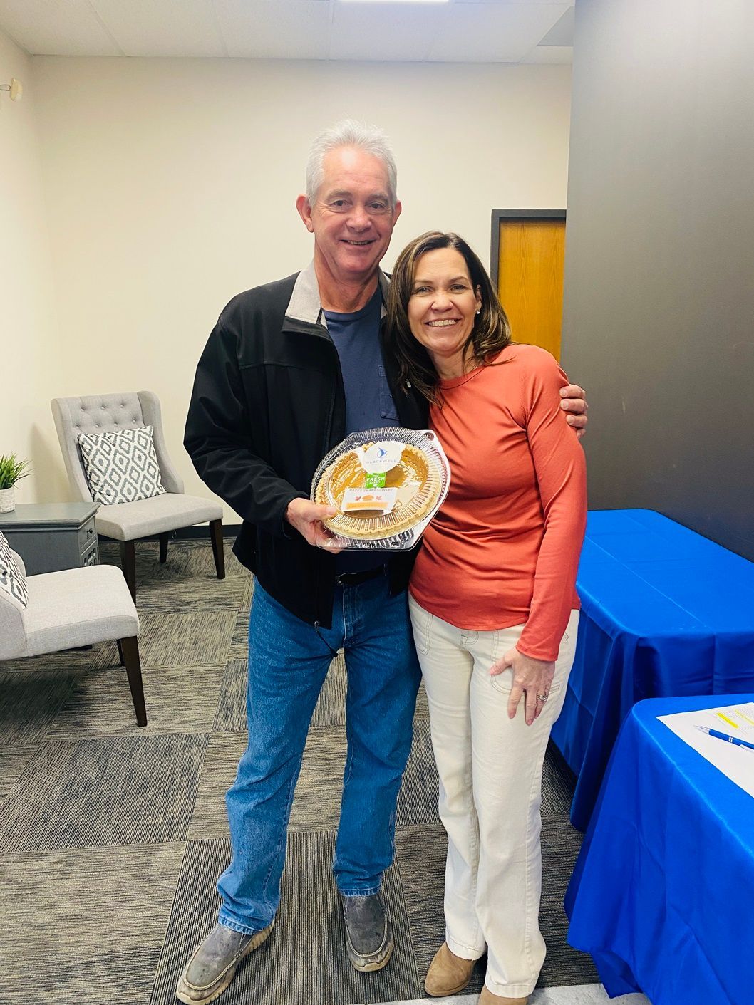 Client picking up their pie at the pumpkin pie give-away